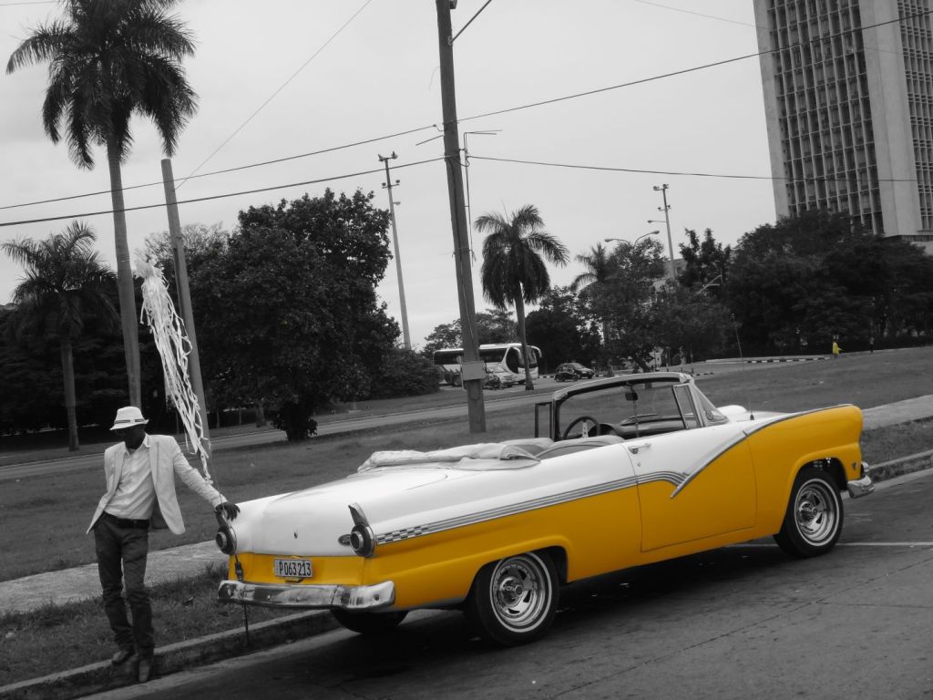 A taxi driver waiting for customers in the centre of Havana, Cuba.