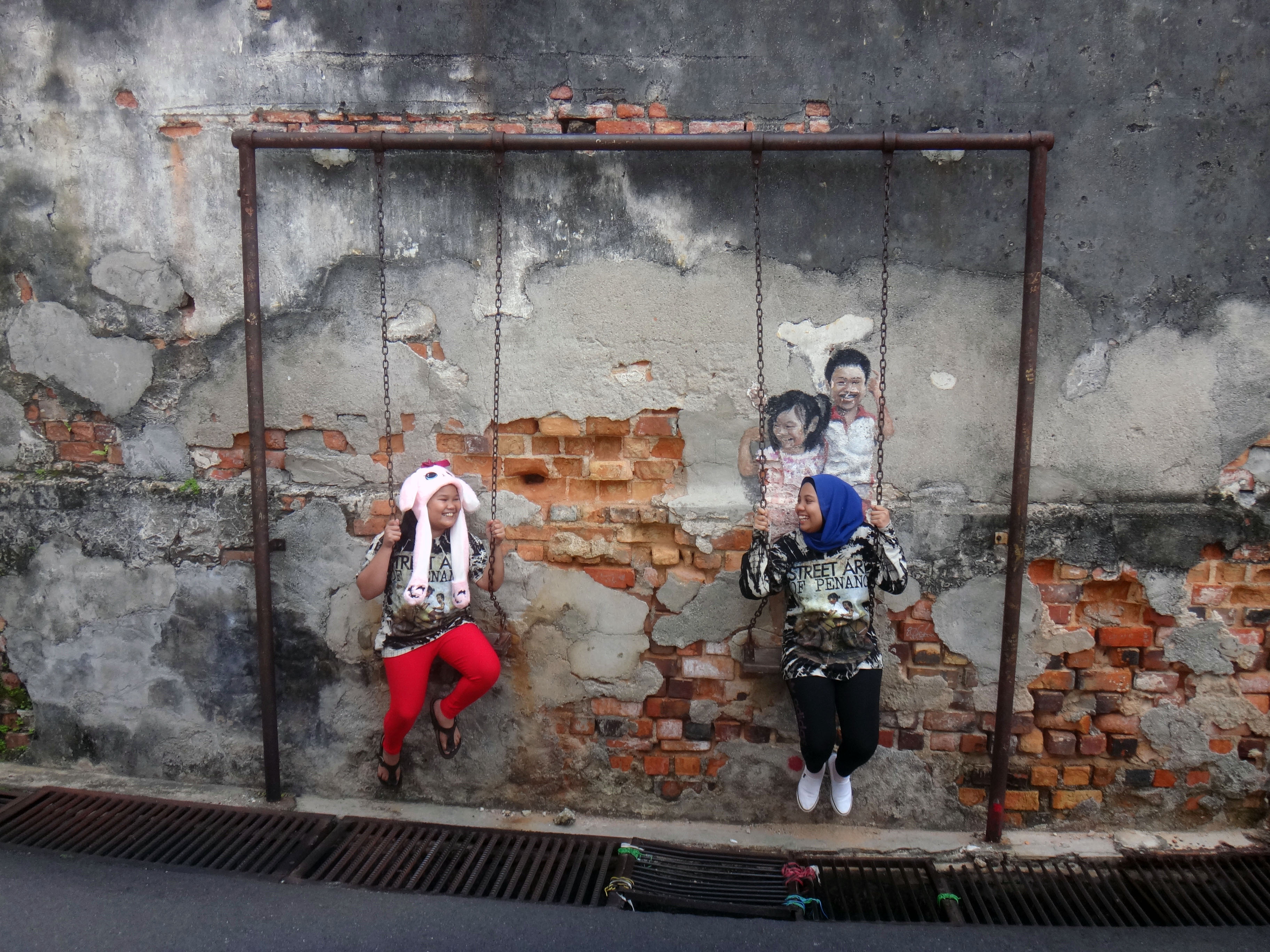 Brother and sister on swing