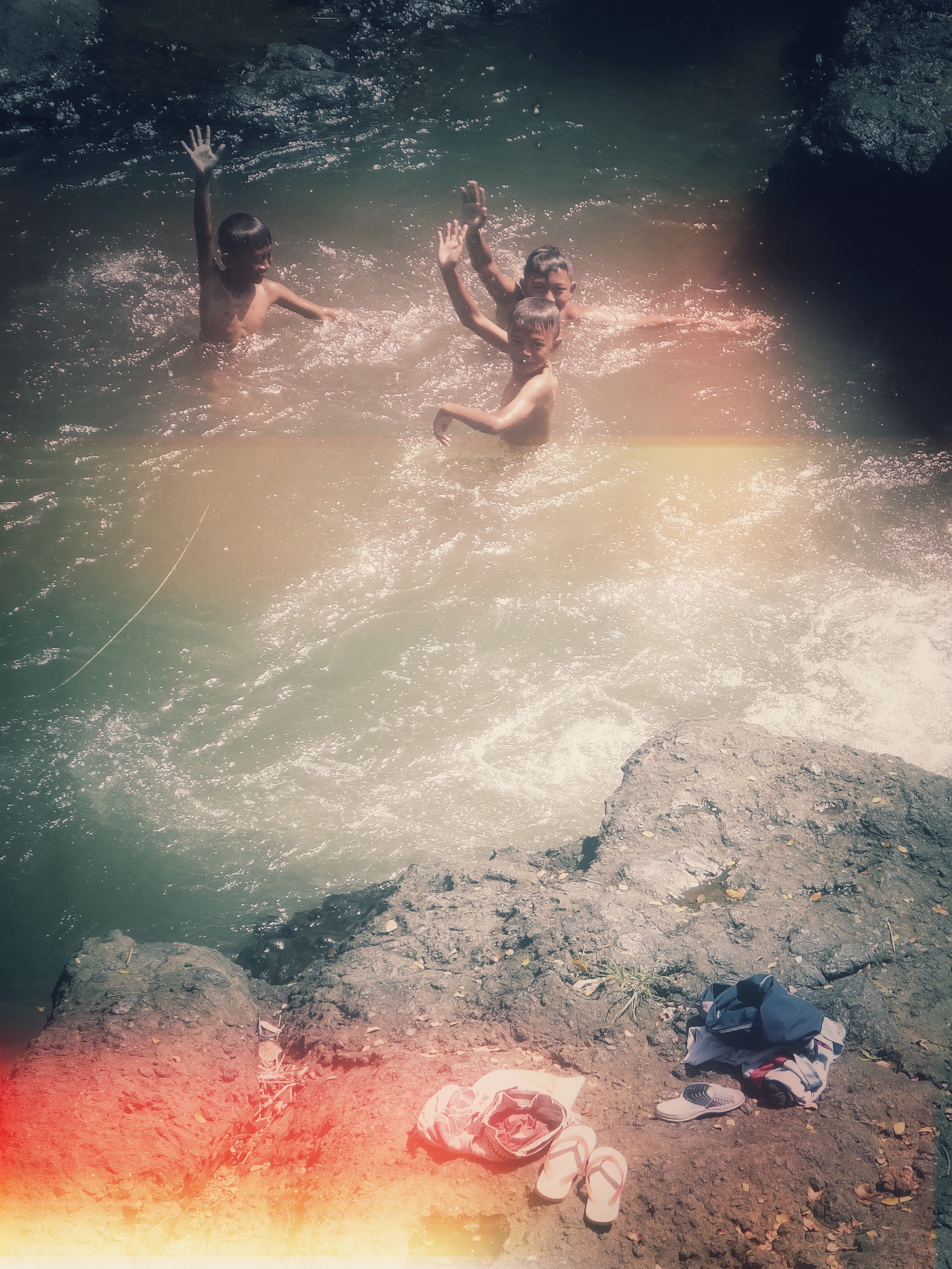 Boys bathing in a river, Java, Indonesia