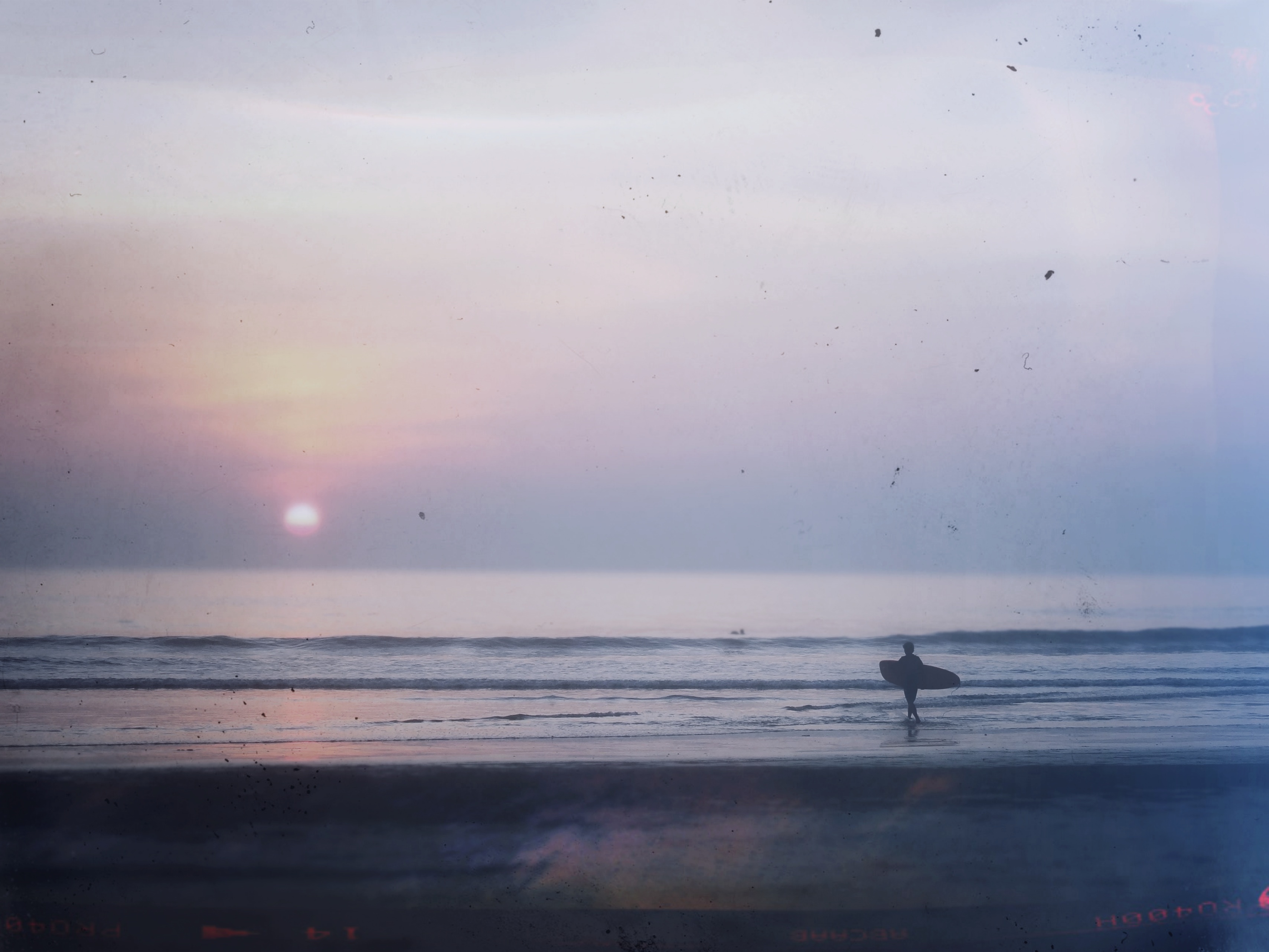 A surfer during sunset at Long Beach, Koh Phayam