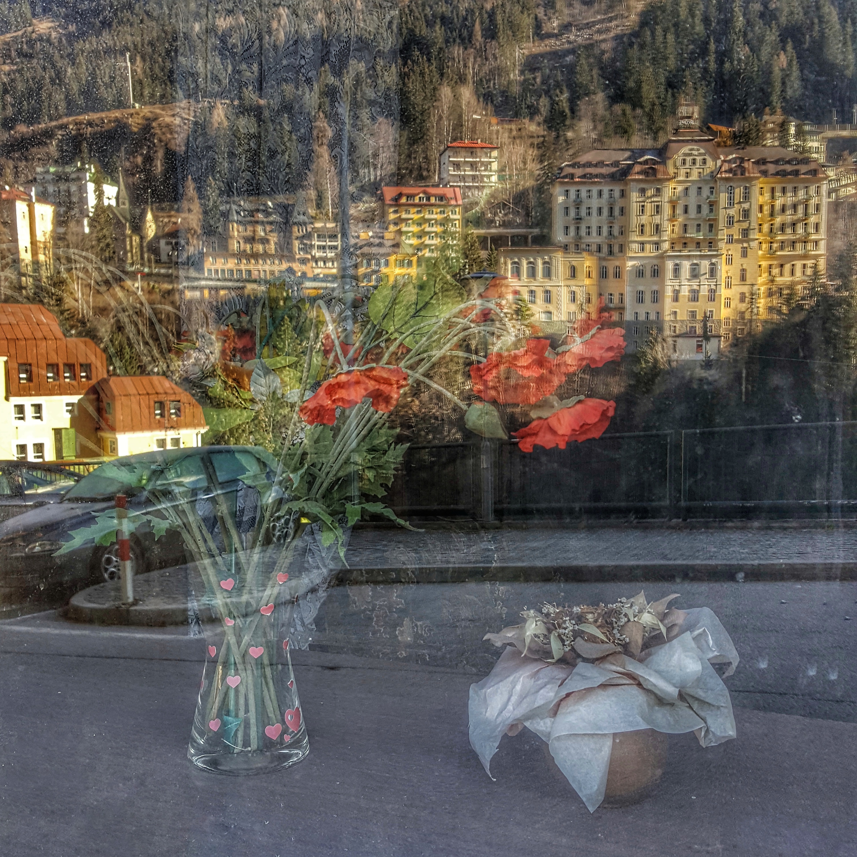 A bouquet of flowers behind a window of Hotel Mirabell